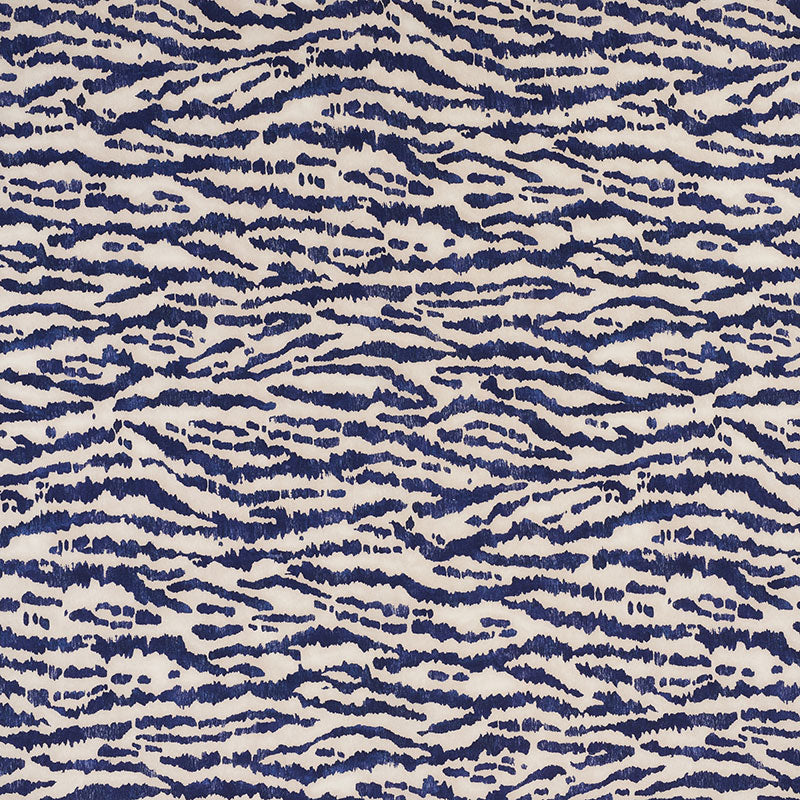 Navy blue wavy zebra-stripe pattern on cream background; bold abstract textile for upholstery or fashion.
