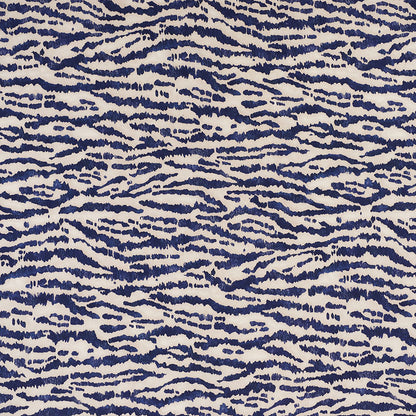 Navy blue wavy zebra-stripe pattern on cream background; bold abstract textile for upholstery or fashion.