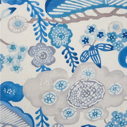 Beige linen-like fabric with blue botanical print: large gray-blue flowers, small blue blossoms, and leafy swirls.