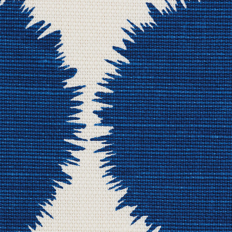 Close-up navy blue fabric with cream central area and jagged, starburst edges.