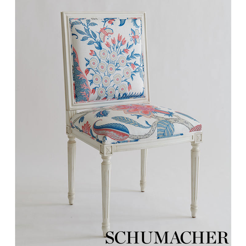 Cream wooden chair with blue-pink floral Schumacher upholstery, square back, tapered carved legs, vintage-style seating.