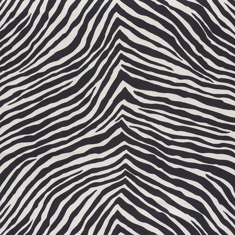 Zebra-print black and white fabric with bold, wavy stripes across the surface