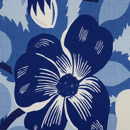Blue floral textile featuring a bold navy flower with white highlights on a pale blue background.