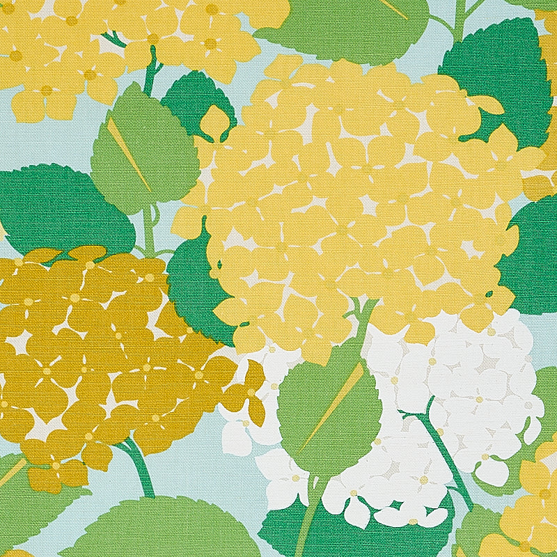 Floral hydrangea pattern with yellow and white blooms and green leaves on a light blue background.