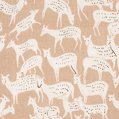 Beige woven fabric with white antelope silhouettes and small black spots in a repeating pattern.