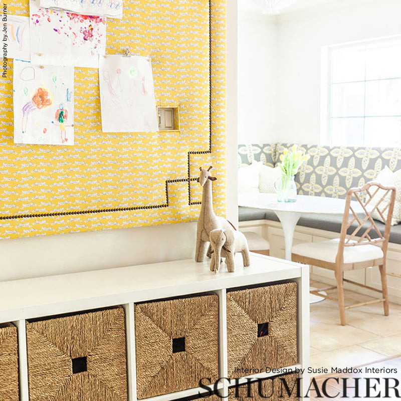 Bright living room with a yellow feature wall and leaping leopard prints artwork.