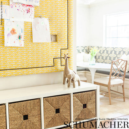 Bright living room with a yellow feature wall and leaping leopard prints artwork.
