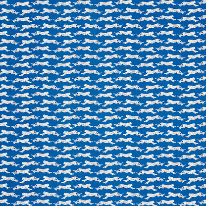 Blue fabric with repeating white leaping leopard silhouettes; seamless, playful leopard-print pattern.