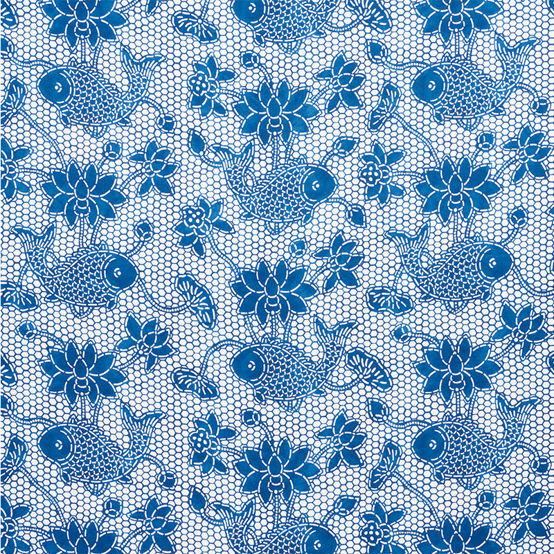 Blue koi fish and floral lace pattern on white mesh fabric; decorative textile for dresses or accessories.