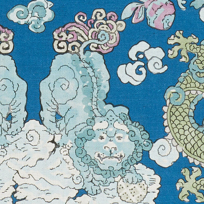 Blue textile with pale teal cloud motifs, curling white clouds, and a gold dragon accent in an oriental print.