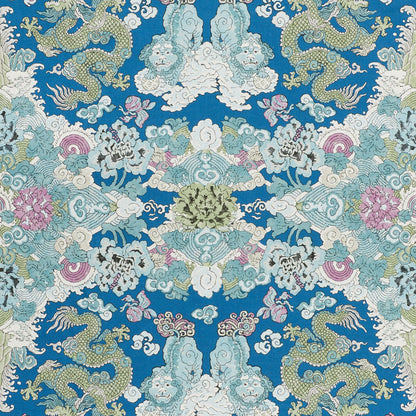Blue decorative fabric with mirrored Chinese dragon and cloud motif in teal, white, pink and gold accents.
