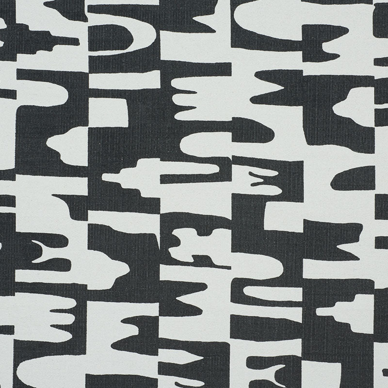 Black and white abstract camo-like textile pattern with irregular, blocky shapes.