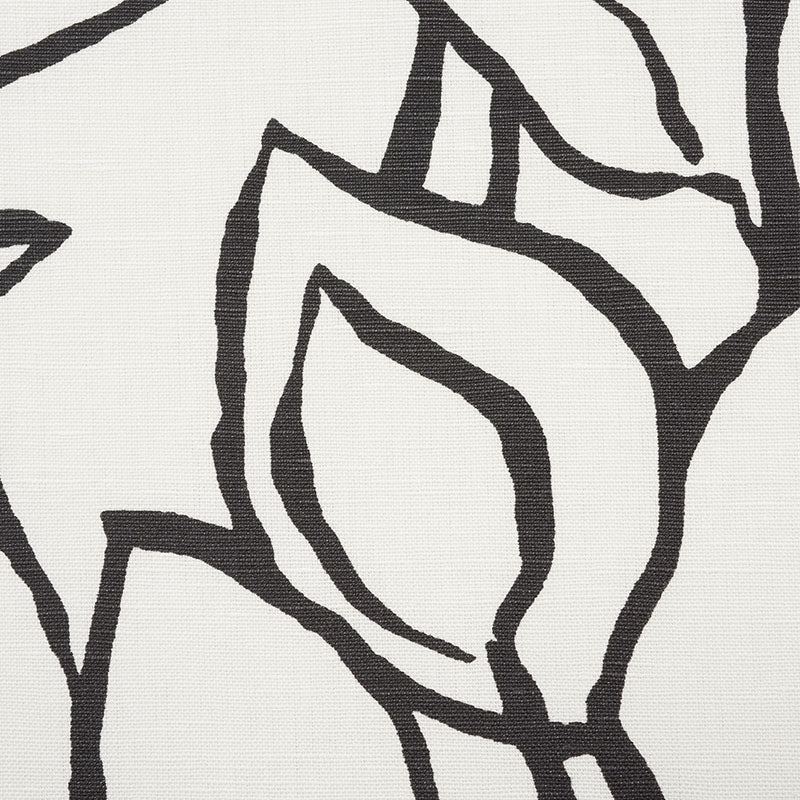 Close-up of a black line-art floral pattern on light beige textured fabric; canvas/linen look.