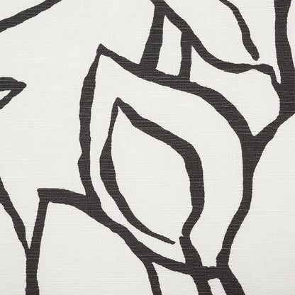 Close-up of a black line-art floral pattern on light beige textured fabric; canvas/linen look.