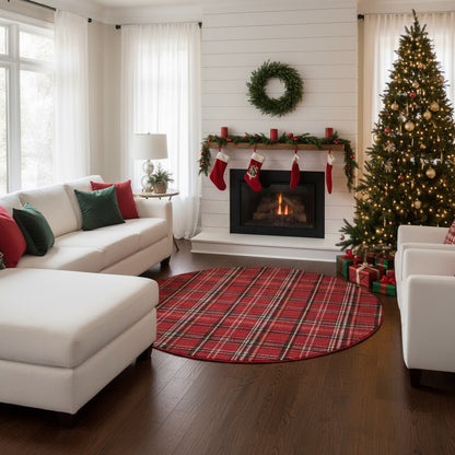 Cozy white living room with L-shaped sofa, red plaid circular rug, Christmas tree, garlanded fireplace with stockings.