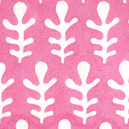 Pink textile with white stylized leaf pattern repeating; linen-like weave.