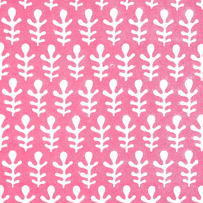 Pink fabric with a repeating white fern-like leaf pattern; bold botanical print for upholstery or curtains.