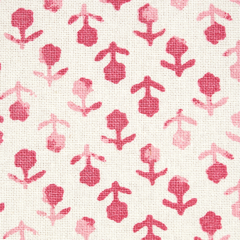 White textured fabric with repeating pink floral motifs in a playful botanical print.