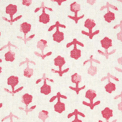 White textured fabric with repeating pink floral motifs in a playful botanical print.