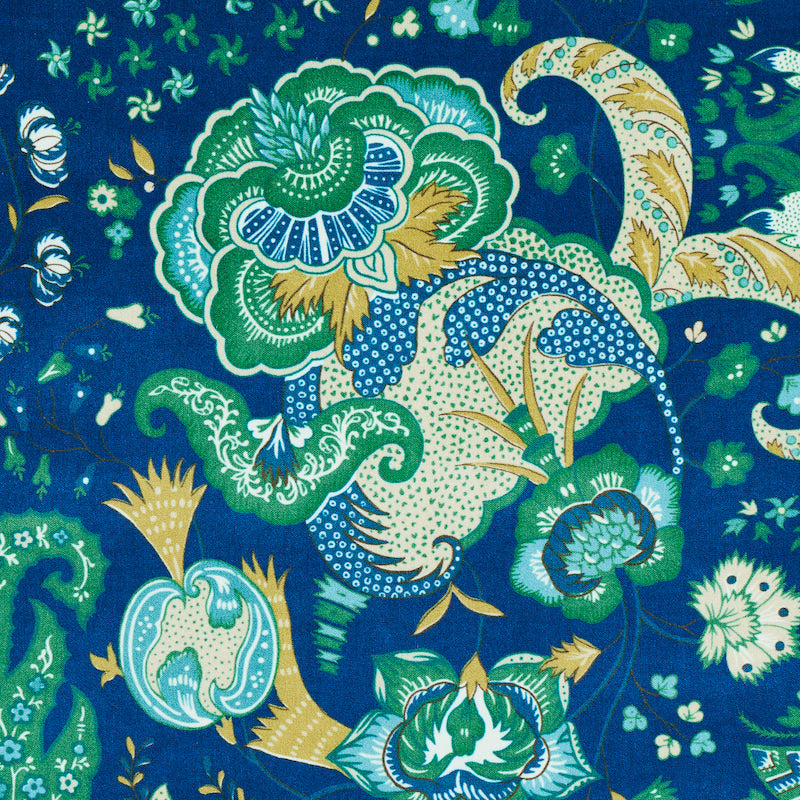 Blue velvet fabric with teal-green florals, gold accents and swirling botanical motifs.