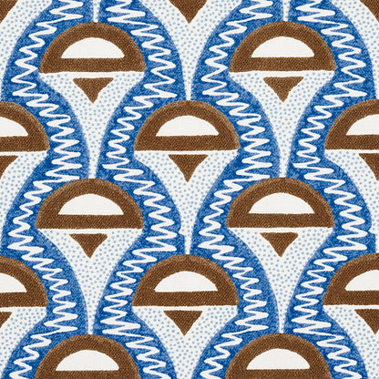 Repeating blue and brown teardrop motif with white arc, bordered by white zigzag lines on fabric.