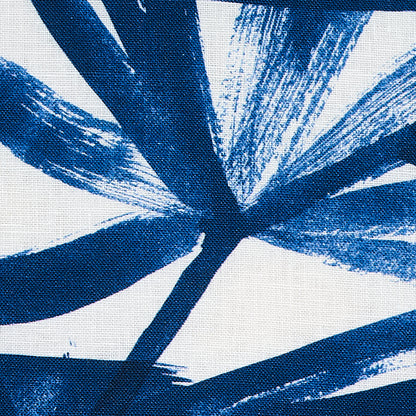 Abstract blue brush-stroke palm-leaf pattern on white textile.