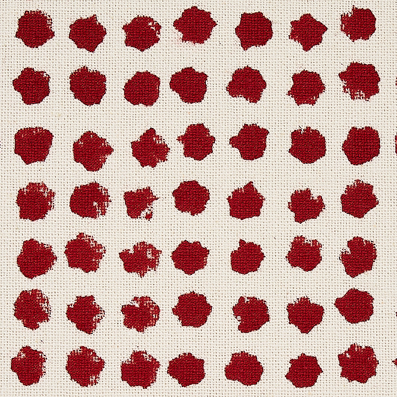 Beige linen fabric with evenly spaced red circular blotch dots in a grid pattern.