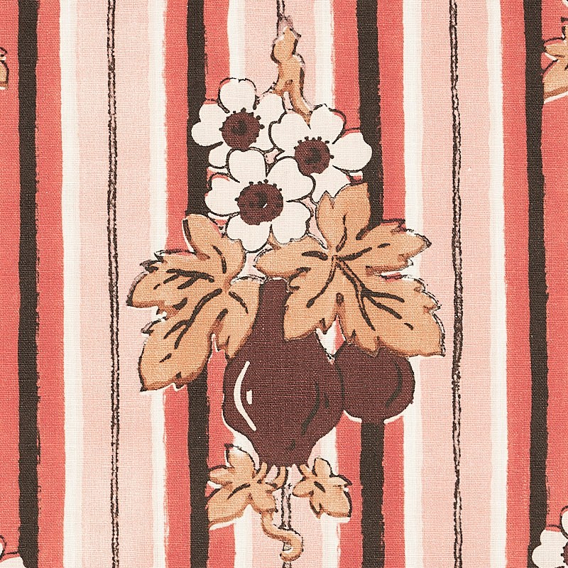 Striped pink, coral and cream textile backdrop featuring a dark brown vase, white flowers and tan leaves.