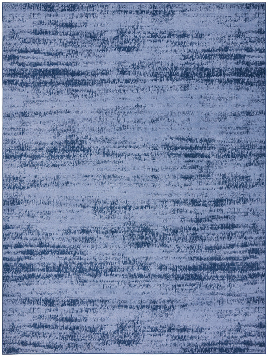 Rectangular blue area rug with an abstract distressed pattern in indigo and denim tones; soft, modern vibe.