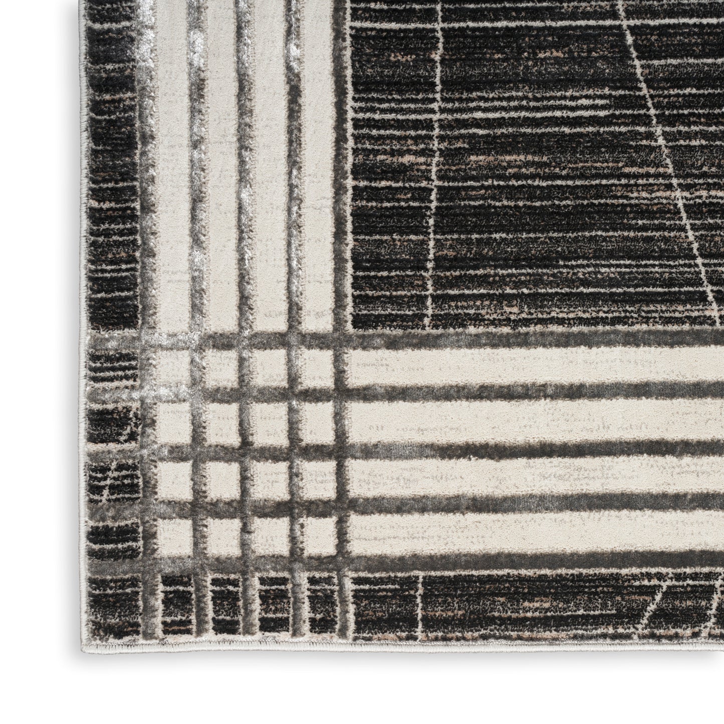 Modern geometric rug in black, beige and white with grid and stripe patterns; plush woven texture.