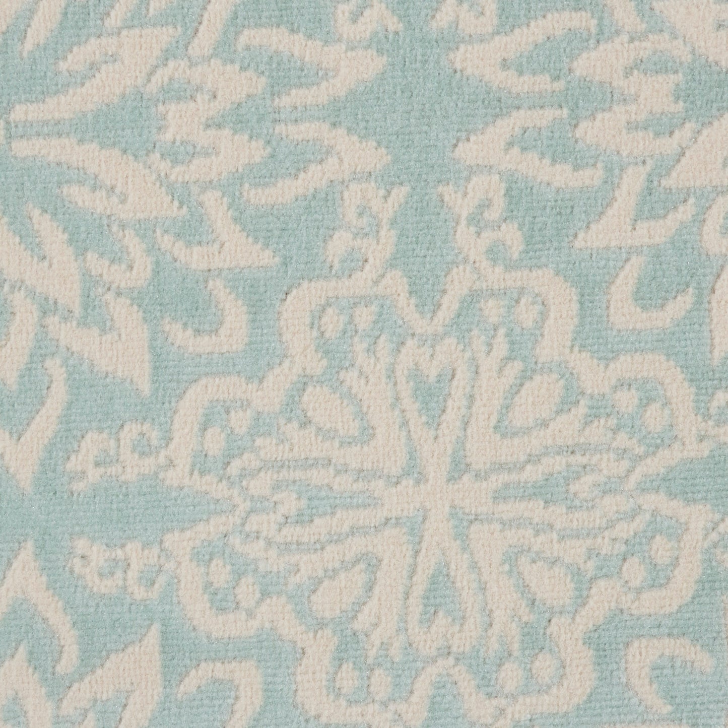 Soft blue rug with white ornamental snowflake/medallion motif; textured surface for home decor.