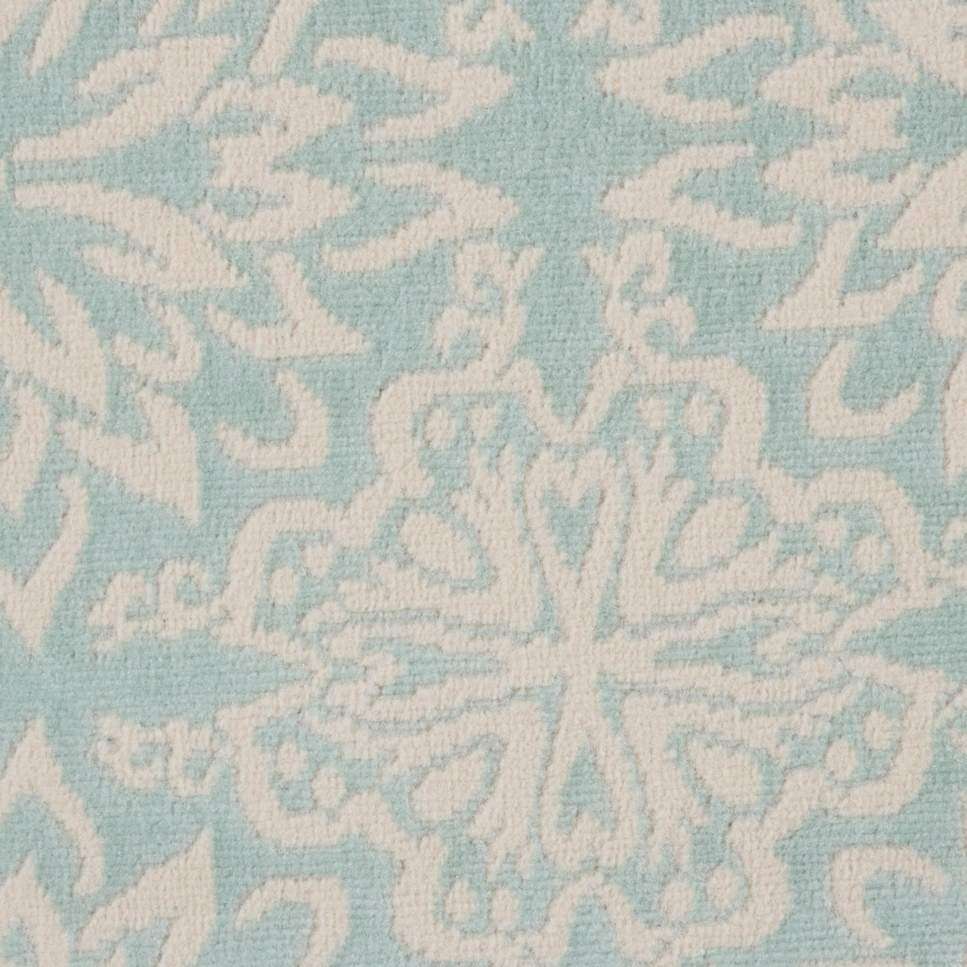 Soft blue rug with white ornamental snowflake/medallion motif; textured surface for home decor.