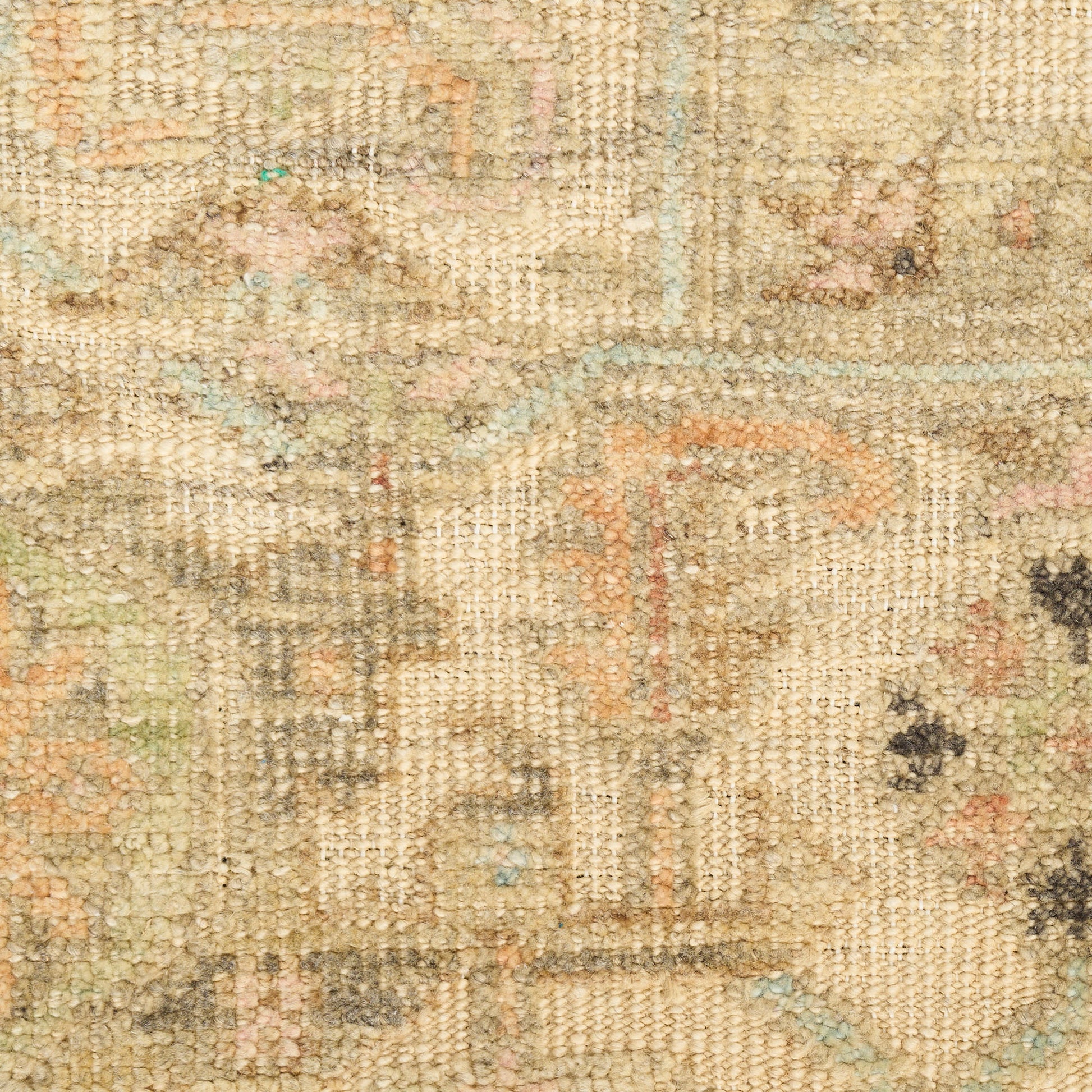 Beige vintage-style woven rug with faded floral motifs in soft apricot, blue, green and gray.