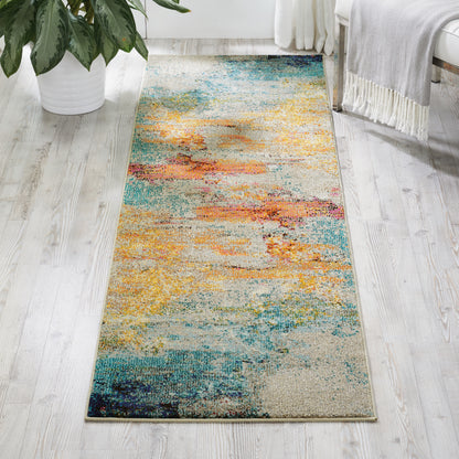 Abstract multicolor area rug with warm and cool tones on light wood floor, in bright room with plant.