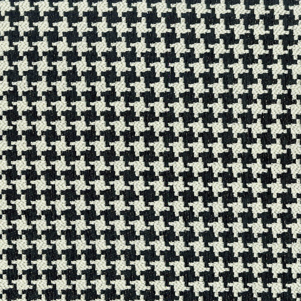 Close-up of black and white houndstooth fabric pattern; woven textile texture for apparel or upholstery.