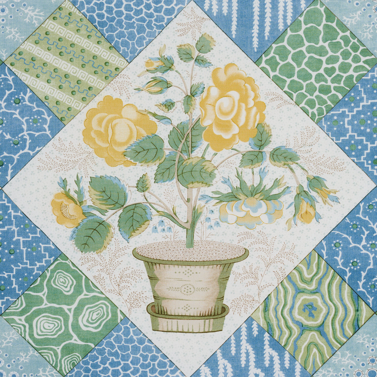 Patchwork quilt block featuring a central potted yellow rose in a diamond frame, surrounded by blue and green patterned patches.
