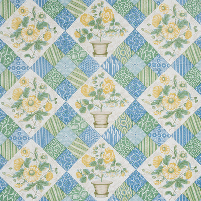 Vintage floral quilt fabric in patchwork diamonds; yellow flowers in vases with blue-green geometric squares.