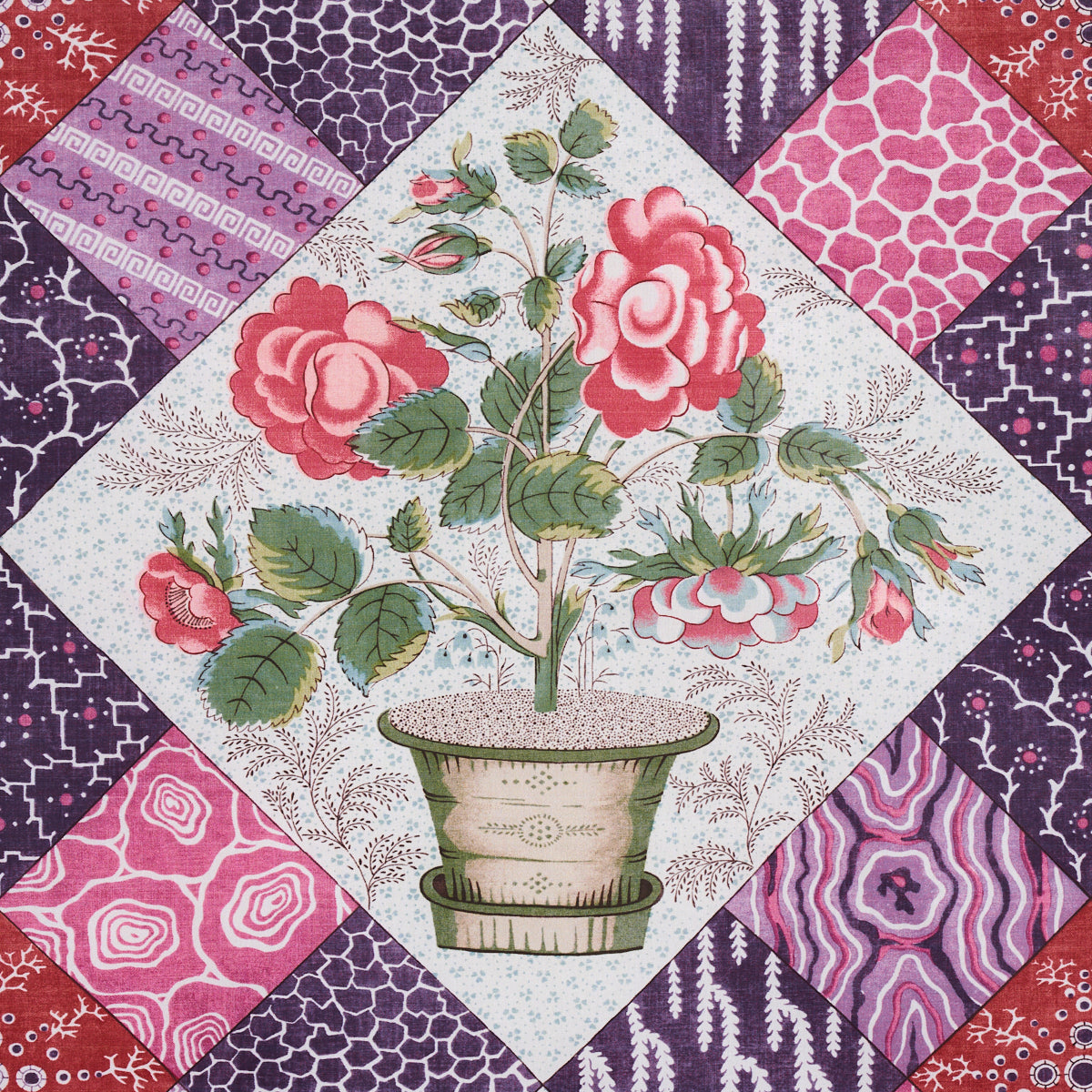 Patchwork quilt panel with central potted rose and surrounding pink, purple, red diamond blocks.