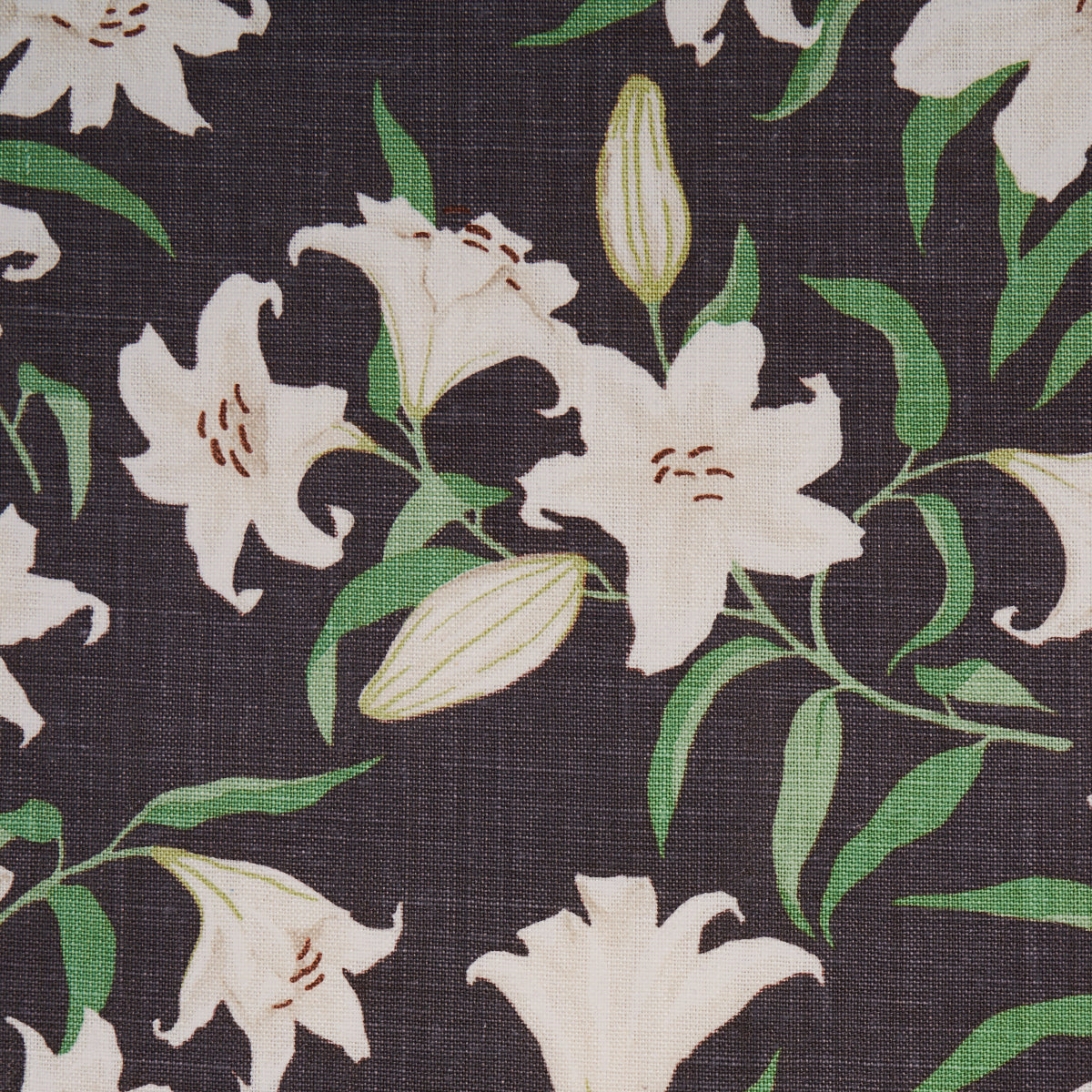 Dark brown fabric with ivory lilies and green leaves floral pattern.