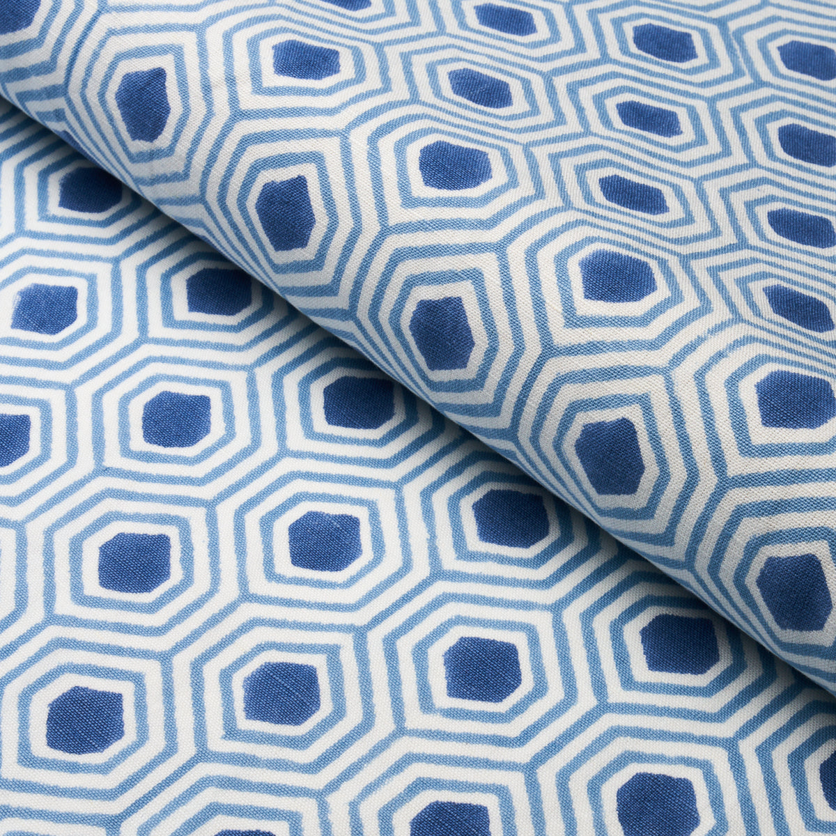 Blue hand-printed fabric, folded, suitable for upholstery or drapery.