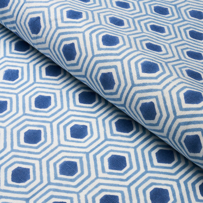 Blue hand-printed fabric, folded, suitable for upholstery or drapery.