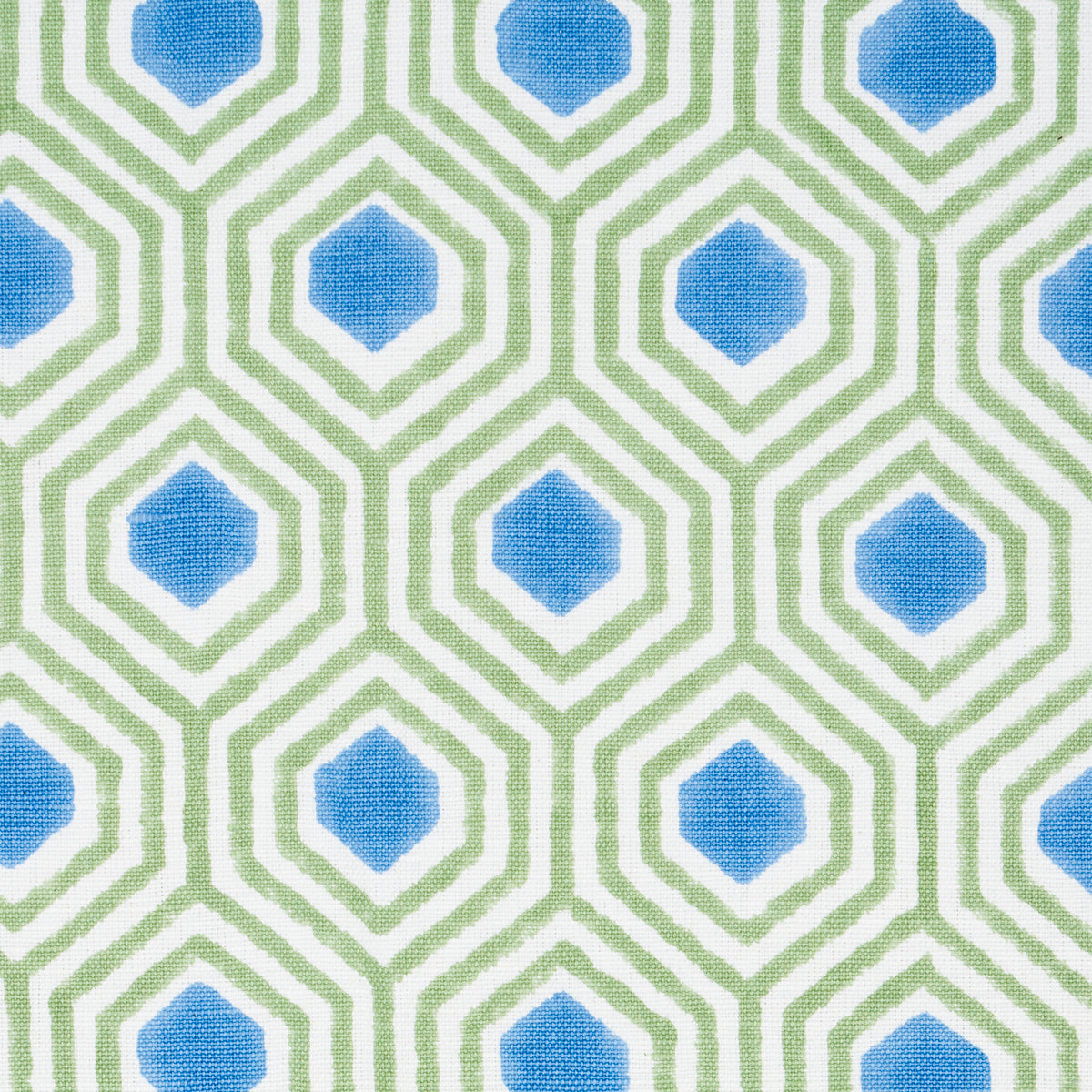 Geometric fabric pattern with blue diamonds centered in lime-green hexagonal lattice, repeating.