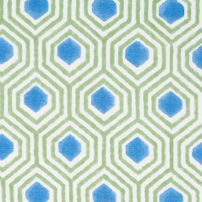Geometric fabric pattern with blue diamonds centered in lime-green hexagonal lattice, repeating.