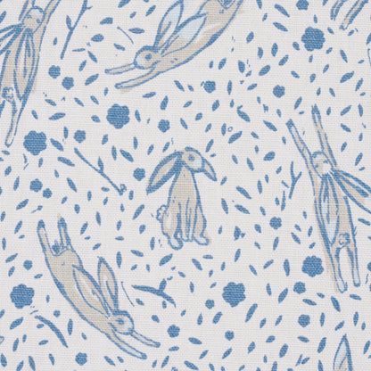 Light blue bunny print on white fabric; whimsical bunnies among scattered leaves.
