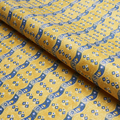 Yellow fabric with blue wavy bands and small diamond motifs; woven textile ideal for crafts or upholstery.