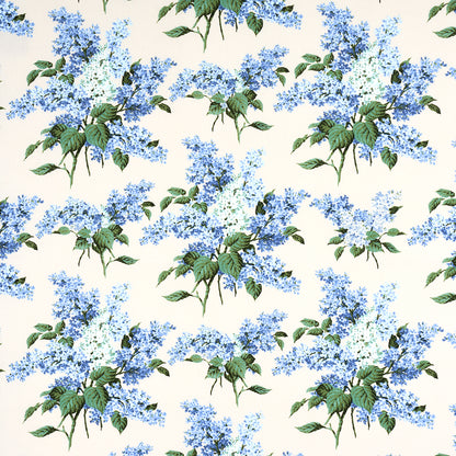Cream background with blue lilac-like flower clusters and green leaves, botanical floral fabric pattern