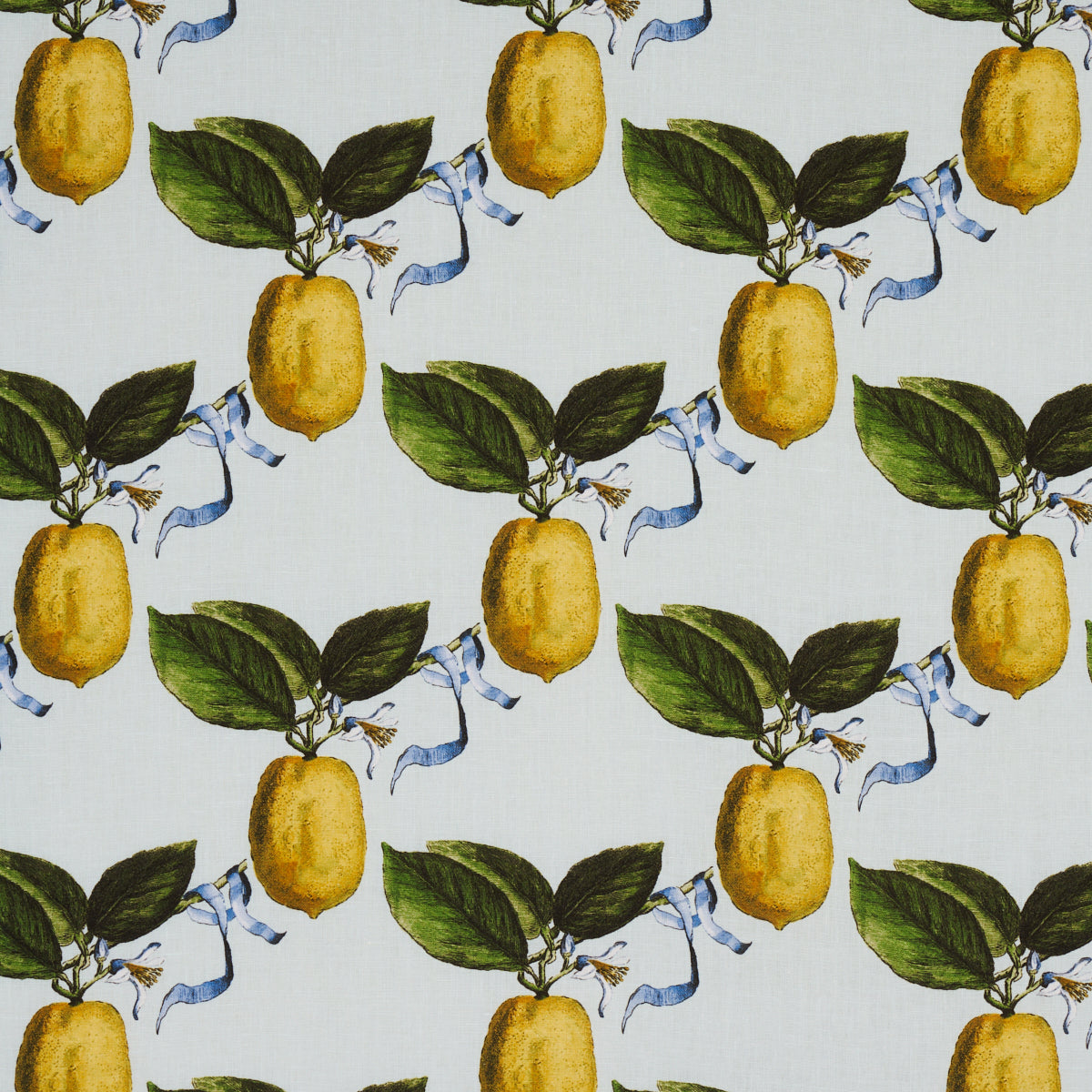 Lemon and leaf fabric pattern with yellow lemons, green leaves, and light blue ribbons on pale blue textile.
