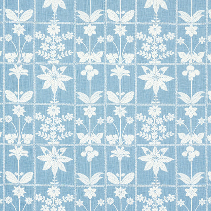 Blue fabric with white floral motifs in a grid-like repeating pattern.