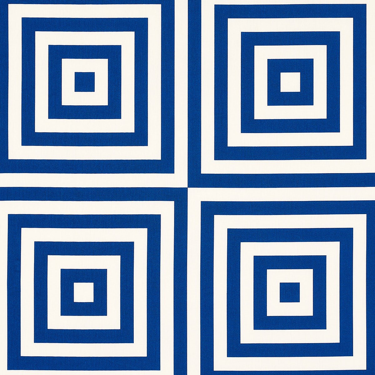 Set of four blue and white ceramic tiles with concentric square rings.