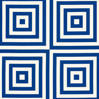 Set of four blue and white ceramic tiles with concentric square rings.